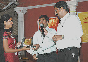 Ameetha receiving the best employee award